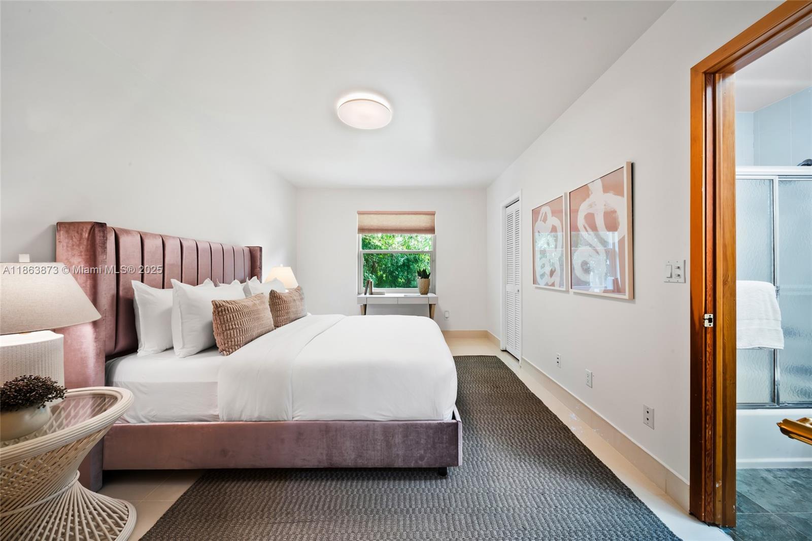 6125 Southwest 109th Street Pinecrest, FL 33156 - Photo 28 of 40 a bedroom with a bed and a window