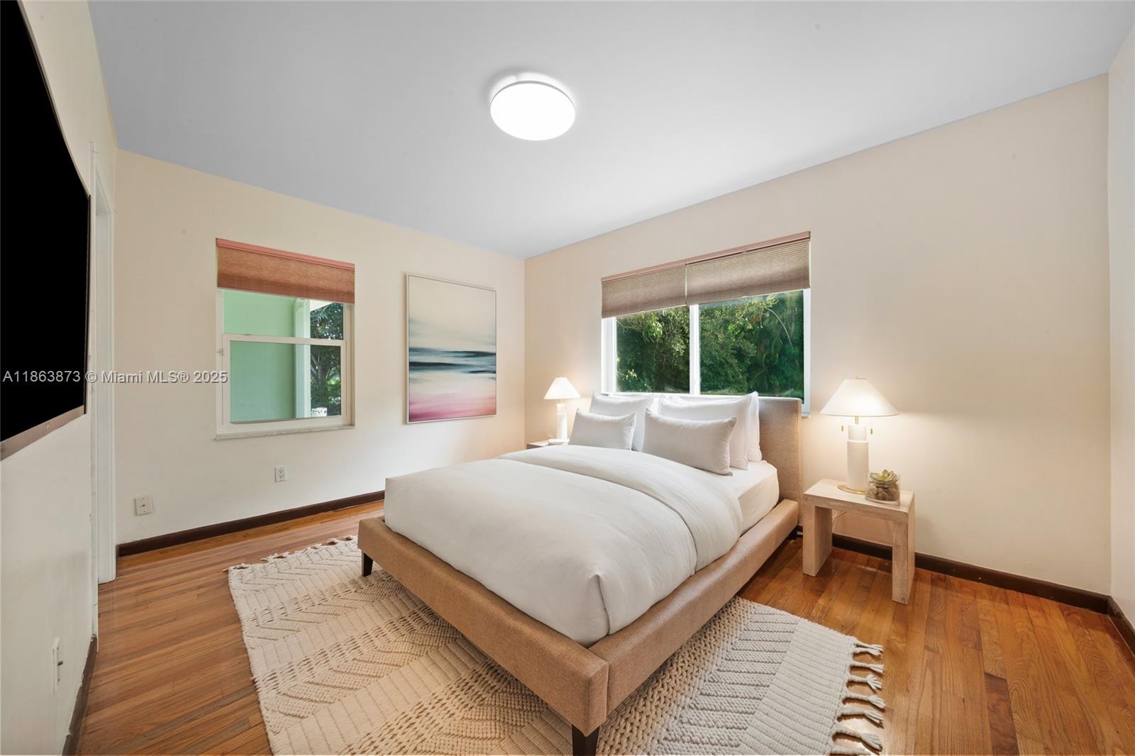 6125 Southwest 109th Street Pinecrest, FL 33156 - Photo 29 of 40 a bedroom with a large bed and a window