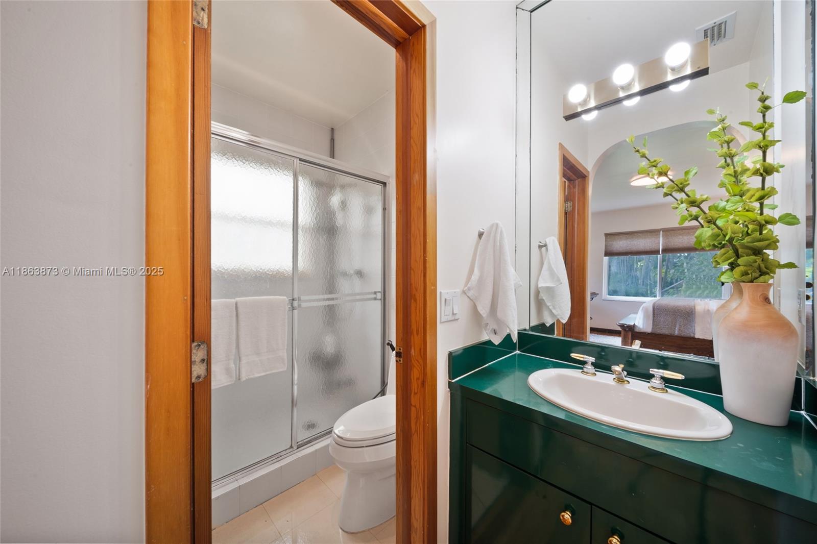 6125 Southwest 109th Street Pinecrest, FL 33156 - Photo 31 of 40 a bathroom with a sink a toilet and shower