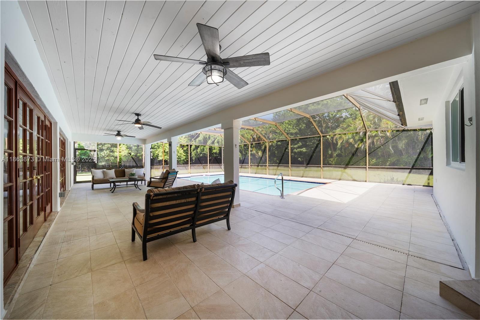6125 Southwest 109th Street Pinecrest, FL 33156 - Photo 32 of 40 a outdoor space with lots of glass windows