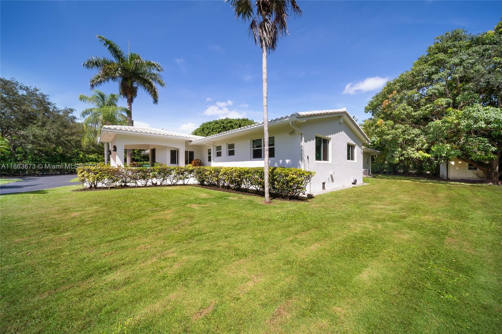 6125 Southwest 109th Street Pinecrest, FL 33156 - Photo 36 of 40 a front view of a house with garden