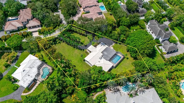 an aerial view of house with a yard and lake view