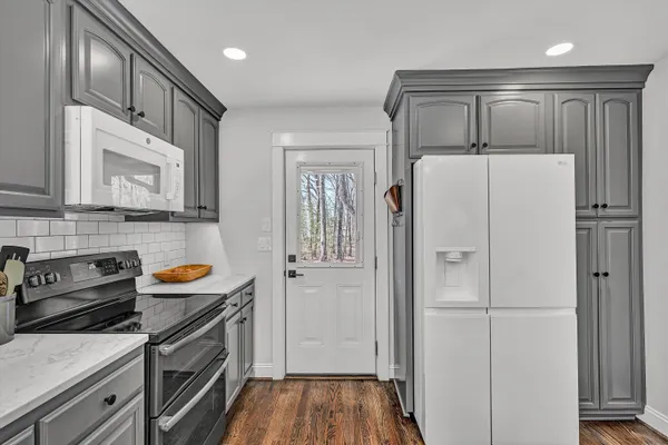 a kitchen with stainless steel appliances a refrigerator a stove a microwave and cabinets