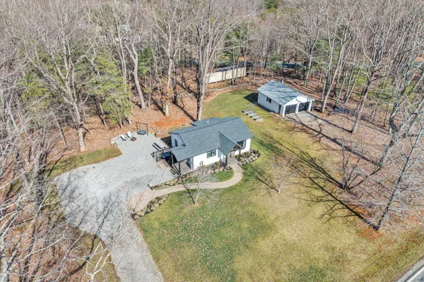 a backyard of a house with table and chairs