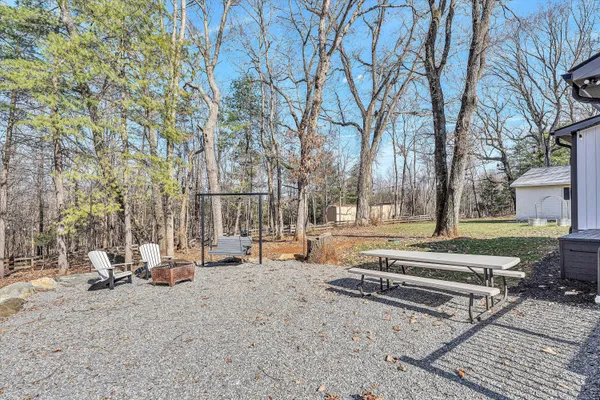 a view of a park with bench and trees