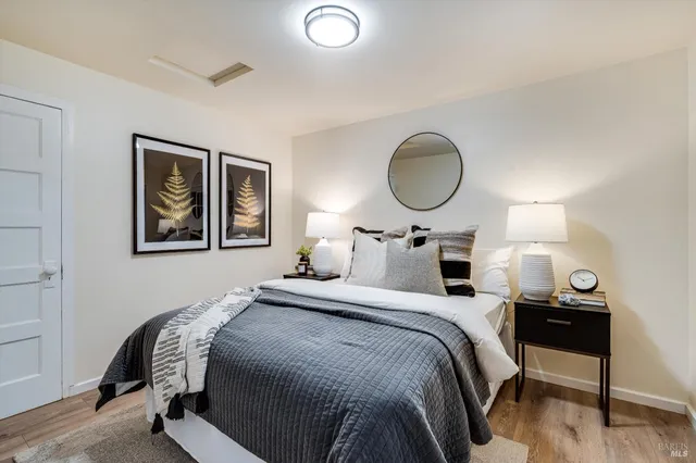 a bedroom with a bed and lamp