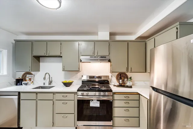 a kitchen with a stove and a refrigerator