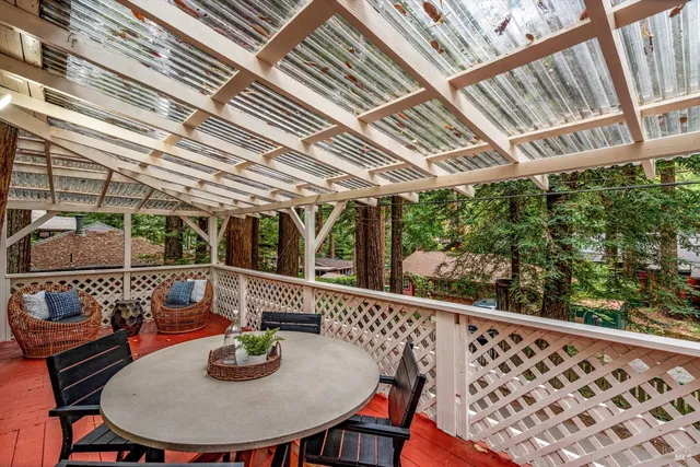 a view of a two chairs and table in the balcony