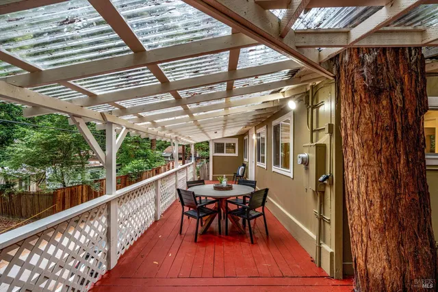 a view of a porch with furniture and wooden floor
