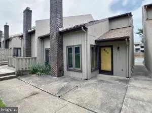 a view of a house with a wooden fence