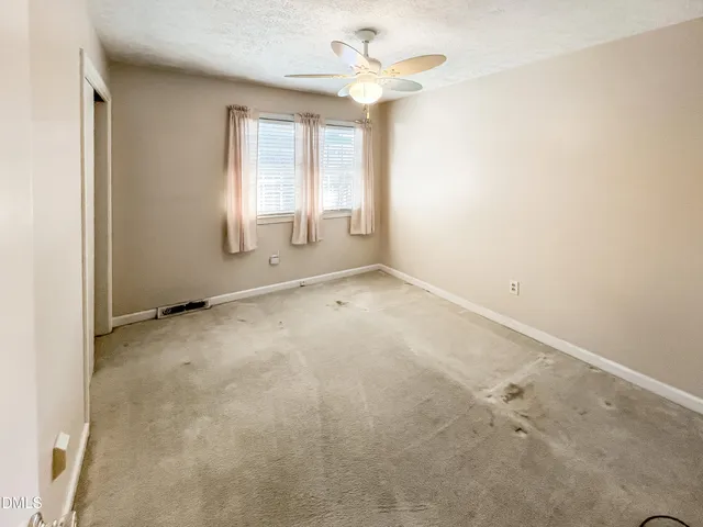 a view of a room that has a bed in it