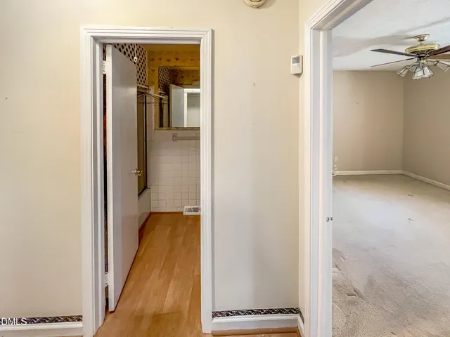 a bathroom with a sink and mirror with bathtub