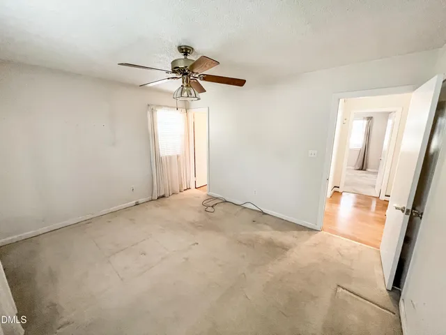 a kitchen with stainless steel appliances granite countertop a refrigerator a stove and white cabinets with wooden floor