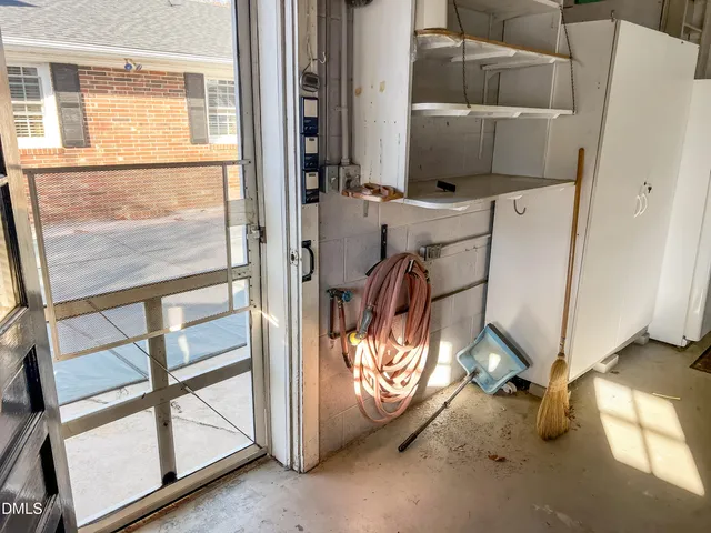 a kitchen with a table chairs microwave and cabinets