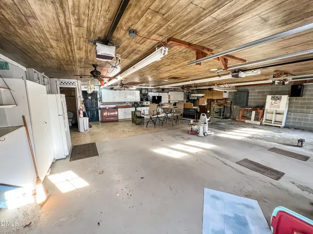 a kitchen with stainless steel appliances kitchen island granite countertop a stove a sink and white cabinets