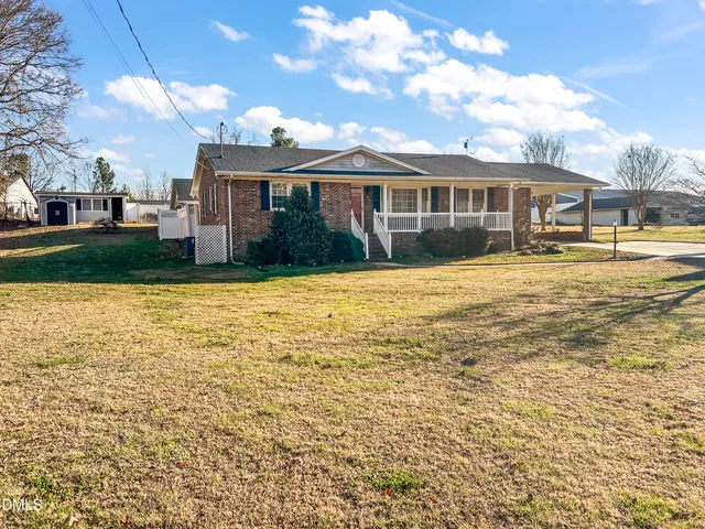 a front view of a house with swimming pool having outdoor seating