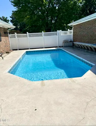 a view of a white house with a yard