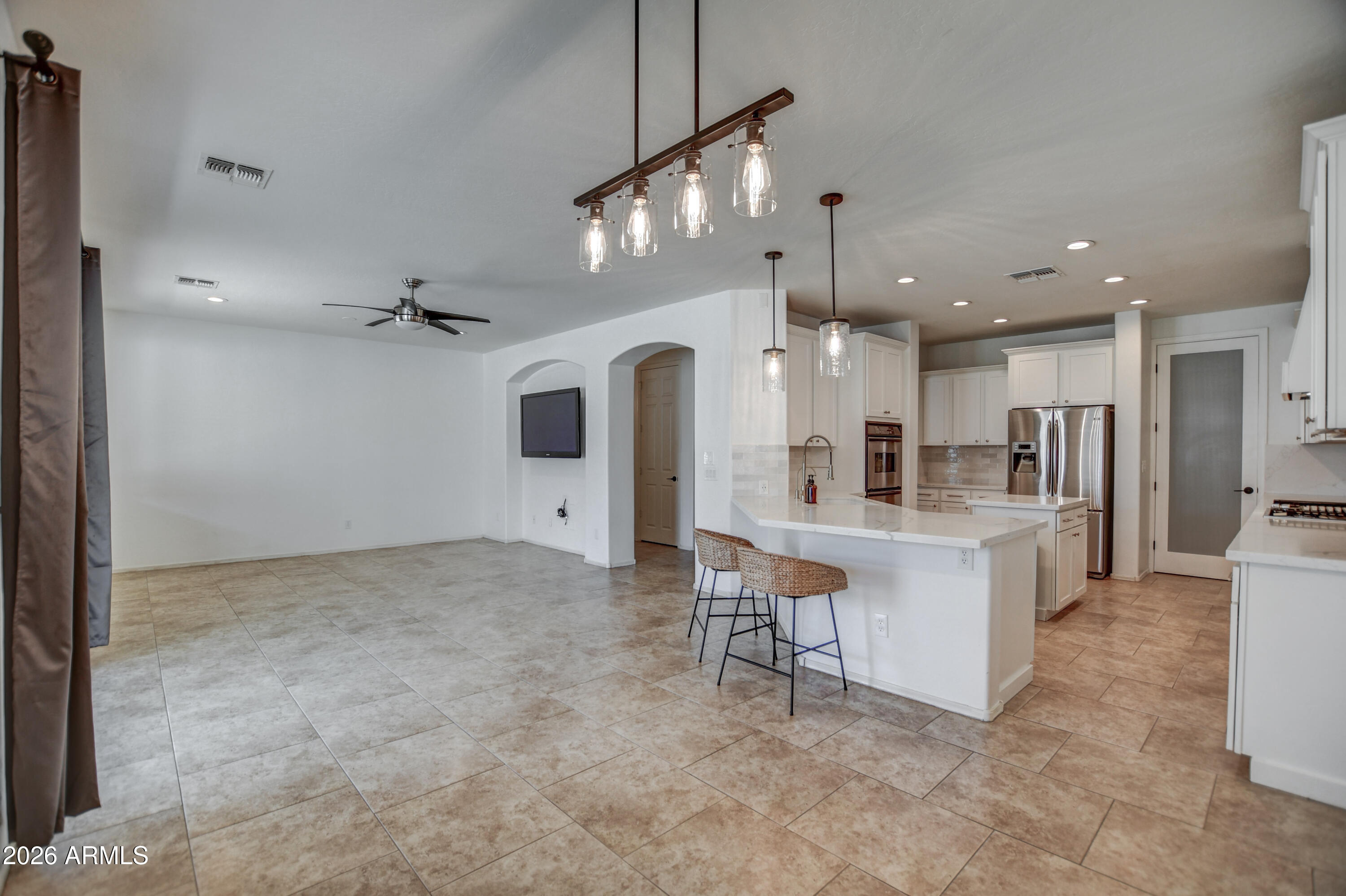 3078 East Muirfield Street Gilbert, AZ 85298 - Photo 32 of 92 a view of kitchen with refrigerator and chairs