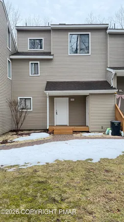 a view of a house with a yard and sitting space