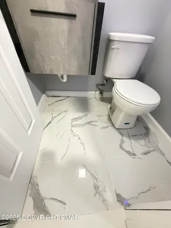 a bathroom with a white toilet sink and bathtub
