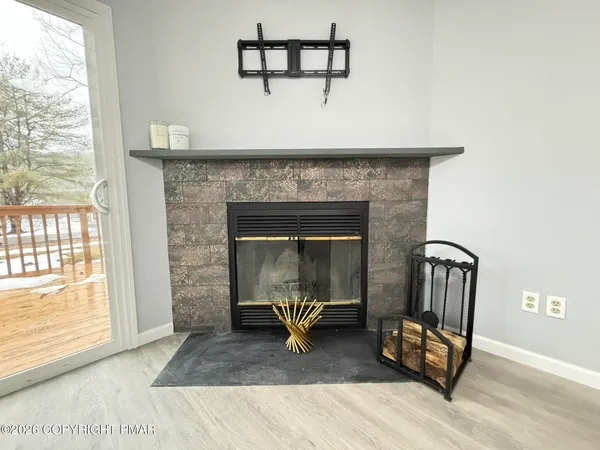 a kitchen with stainless steel appliances granite countertop a refrigerator a stove and a sink with wooden floor