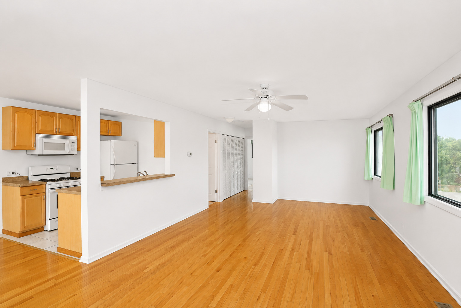 707 Sunfish Point, Unit 707 Schaumburg, IL 60194 - Photo 7 of 20 a view of a kitchen with wooden floor and a kitchen