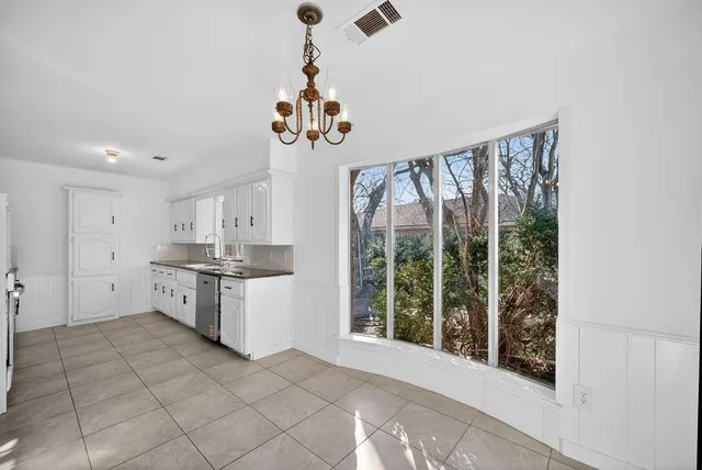 a kitchen with a refrigerator a sink and cabinets