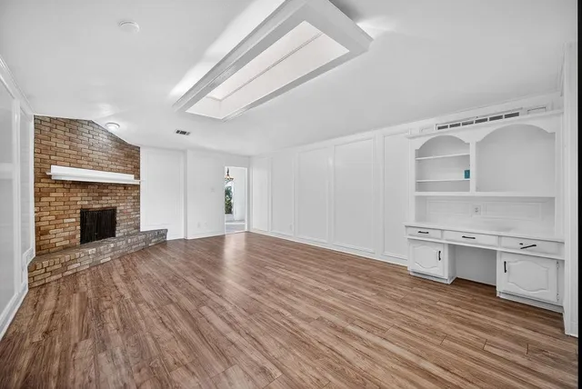 a view of a kitchen with wooden floor and a sink