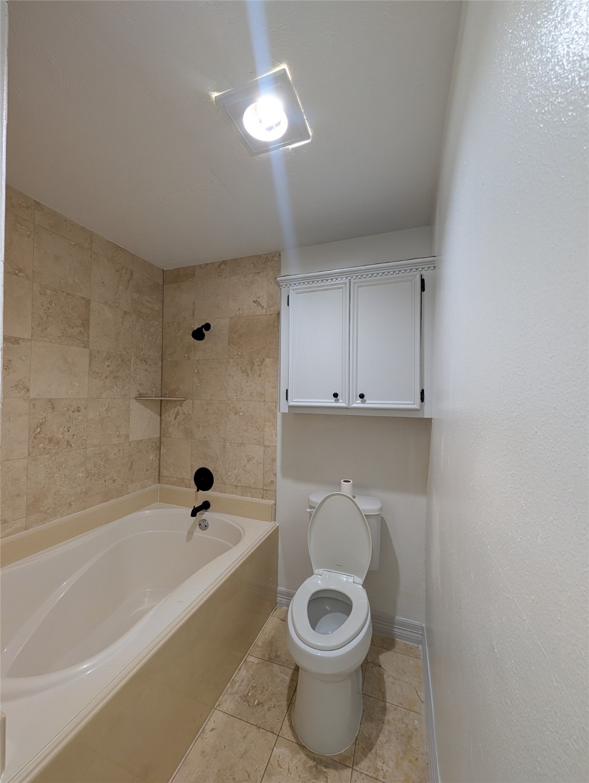 5903 Graycliff Drive Houston, TX 77049 - Photo 14 of 14 a bathroom with a bathtub and a toilet