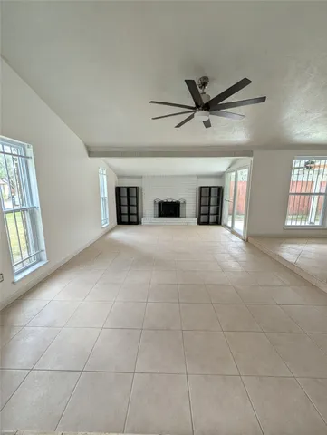 a view of a livingroom with a ceiling fan and window