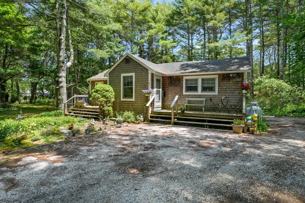 a front view of a house with garden