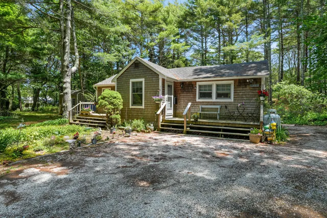 a front view of a house with garden