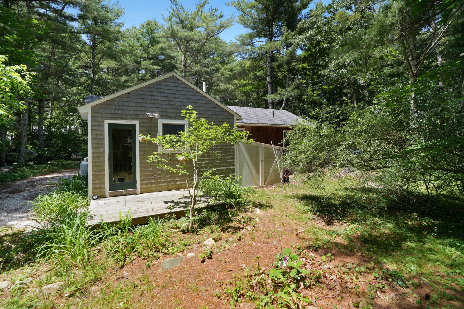 21 Clay Pit Road Edgartown, MA 02539 - Photo 18 of 20 a front view of a house with a yard and trees