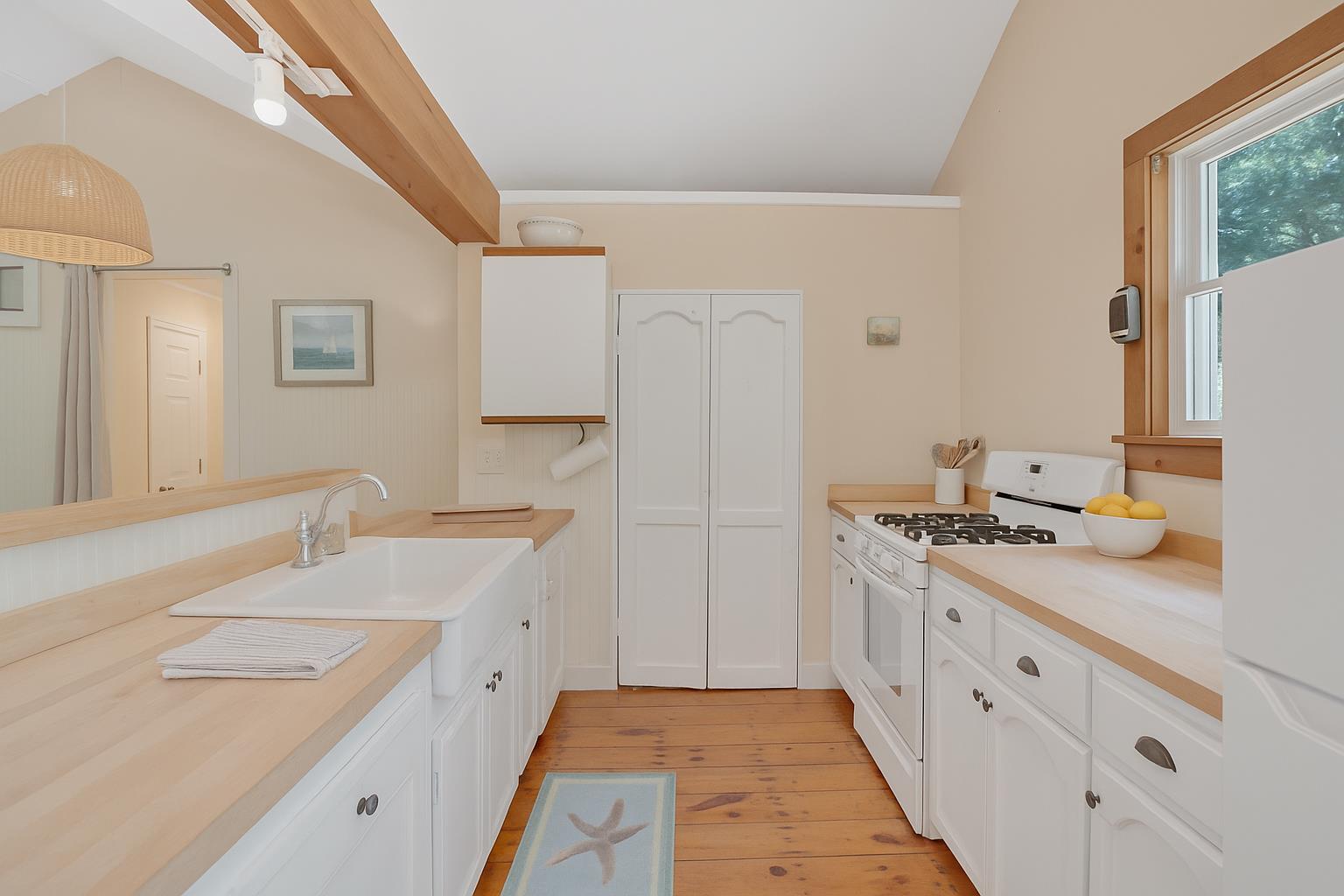 21 Clay Pit Road Edgartown, MA 02539 - Photo 9 of 20 a spacious bathroom with a double vanity sink and mirror