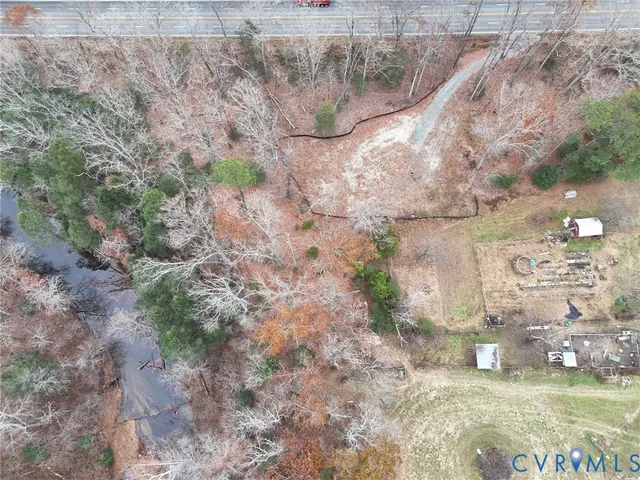 a view of a dry yard with wooden fence