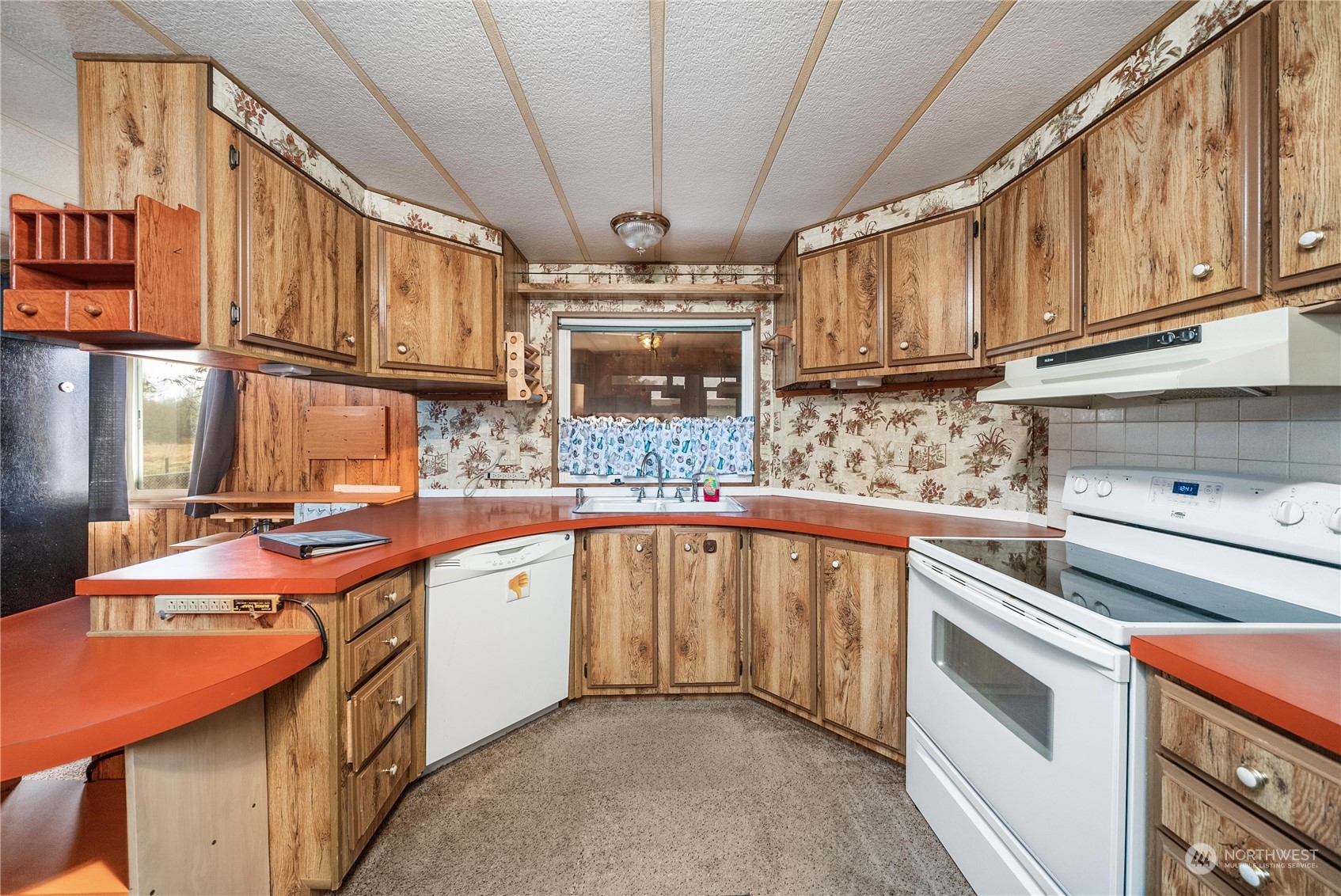 321 2nd Street Roy, WA 98580 - Photo 7 of 16 a kitchen with stainless steel appliances granite countertop a sink stove and cabinets