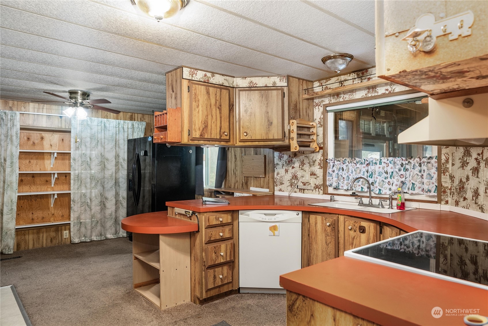 321 2nd Street Roy, WA 98580 - Photo 8 of 16 a room with stainless steel appliances kitchen island granite countertop a sink and cabinets