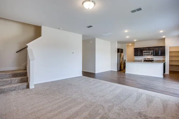 a kitchen with stainless steel appliances granite countertop a stove refrigerator and microwave