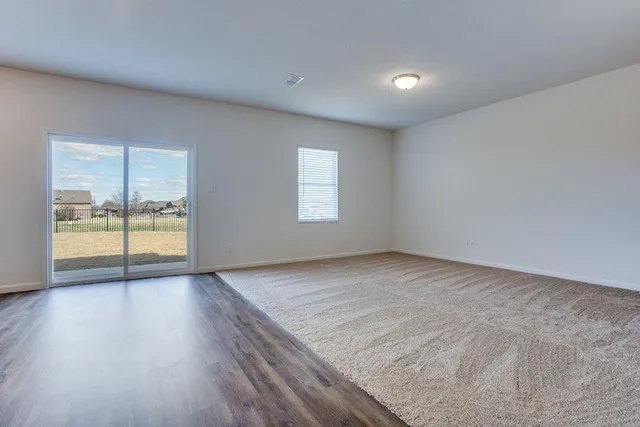 a view of a kitchen with a sink and a refrigerator