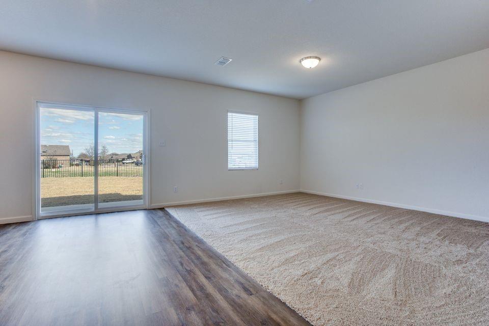 1917 Briar Cove Anna, TX 75409 - Photo 5 of 10 an empty room with wooden floor and windows
