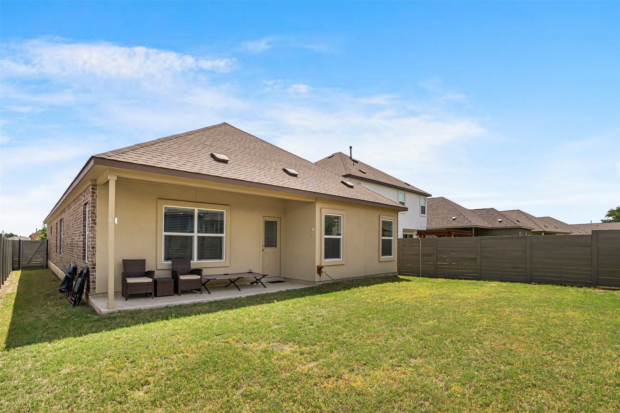 124 Cherry Ridge Road Georgetown, TX 78628 - Photo 21 of 23 Expansive backyard featuring a covered concrete patio, stucco and brick exterior, and a privacy fence