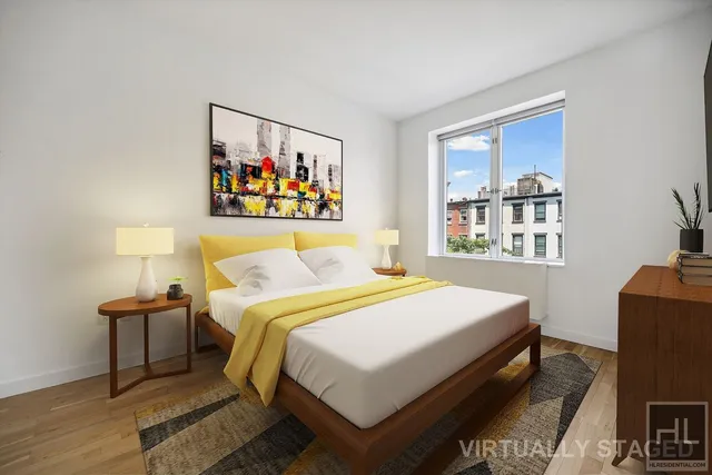 a bedroom with a bed and a painting on the wall