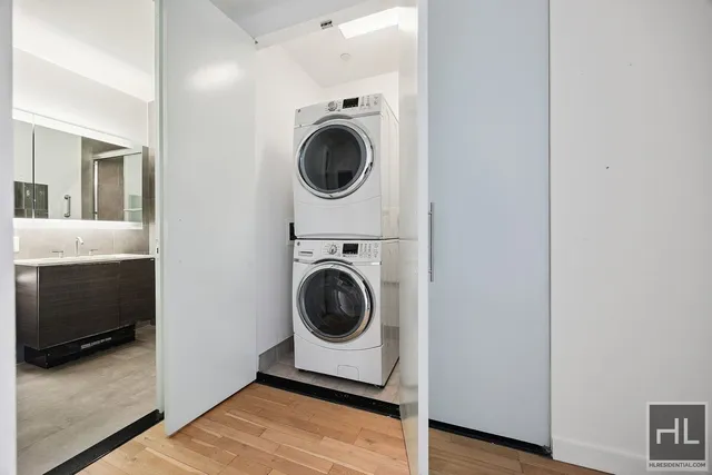 a utility room with washing machine and a view of bedroom
