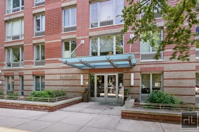 a front view of a building with garden and plants