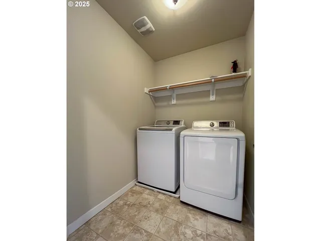 a spacious bathroom with a granite countertop sink a toilet and a mirror