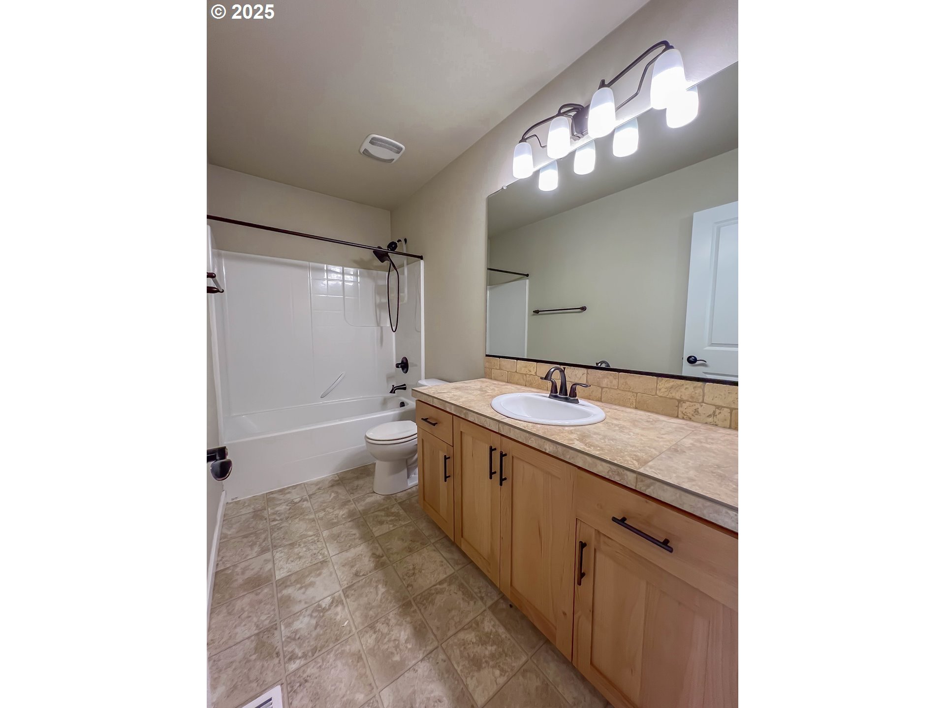 386 Southwest 203rd Terrace Beaverton, OR 97006 - Photo 16 of 24 a spacious bathroom with a granite countertop sink a toilet and a mirror