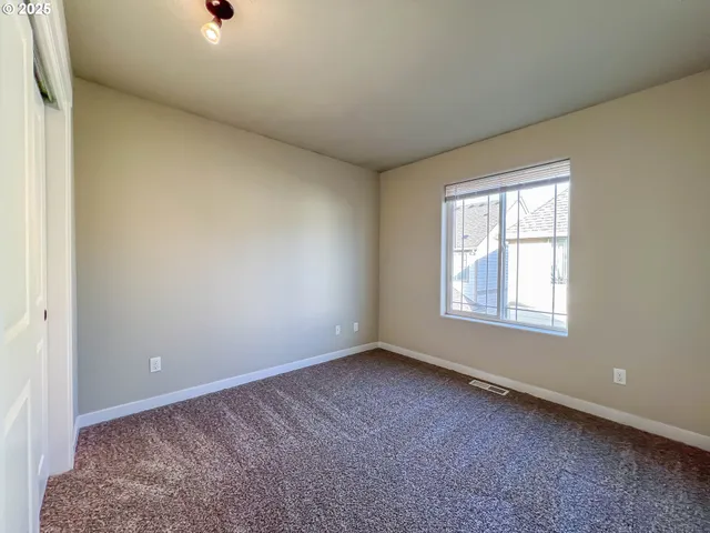 an empty room with closet area