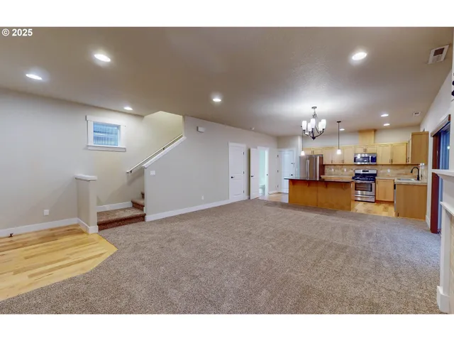 a living room with furniture and a kitchen