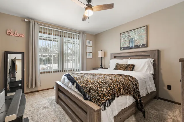 a bed sitting in a bedroom next to a window