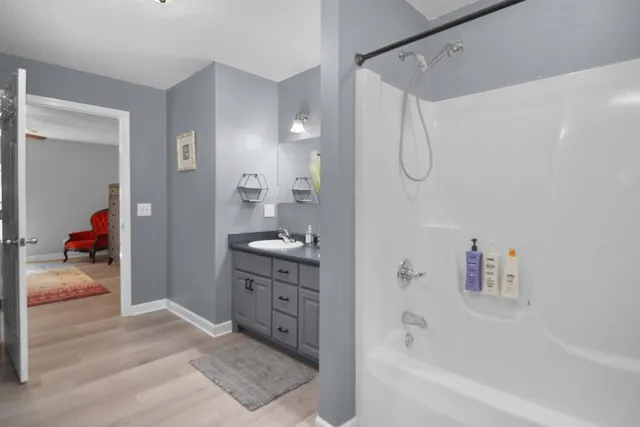a bathroom with a granite countertop sink a shower and a mirror